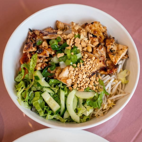 Miss Saigon Cafe's grilled chicken vermicelli bowl with peanuts, scallions, lettuce, cucumbers, and bean sprouts.